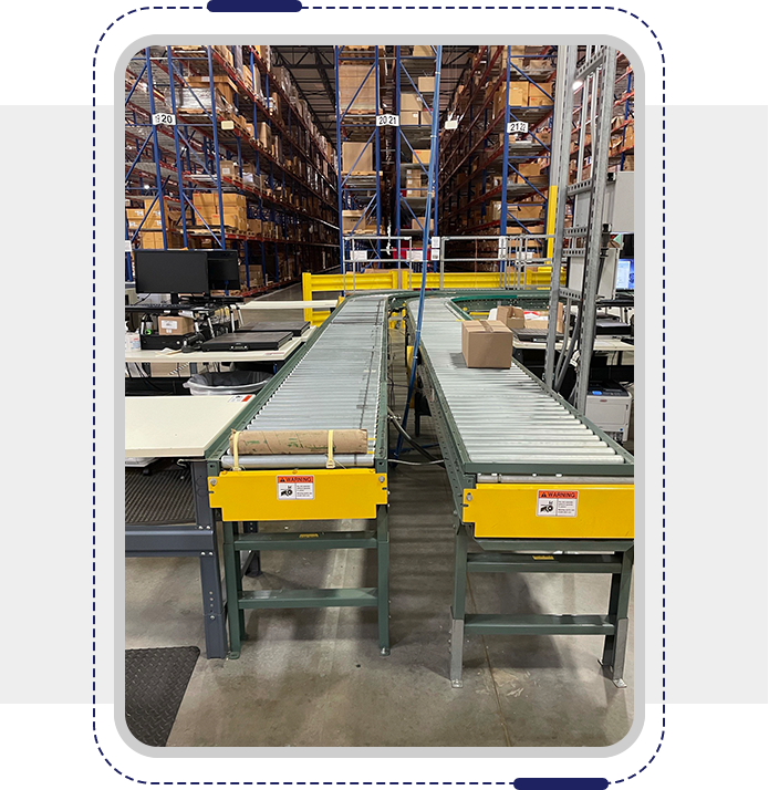 A warehouse with two conveyors and many shelves.